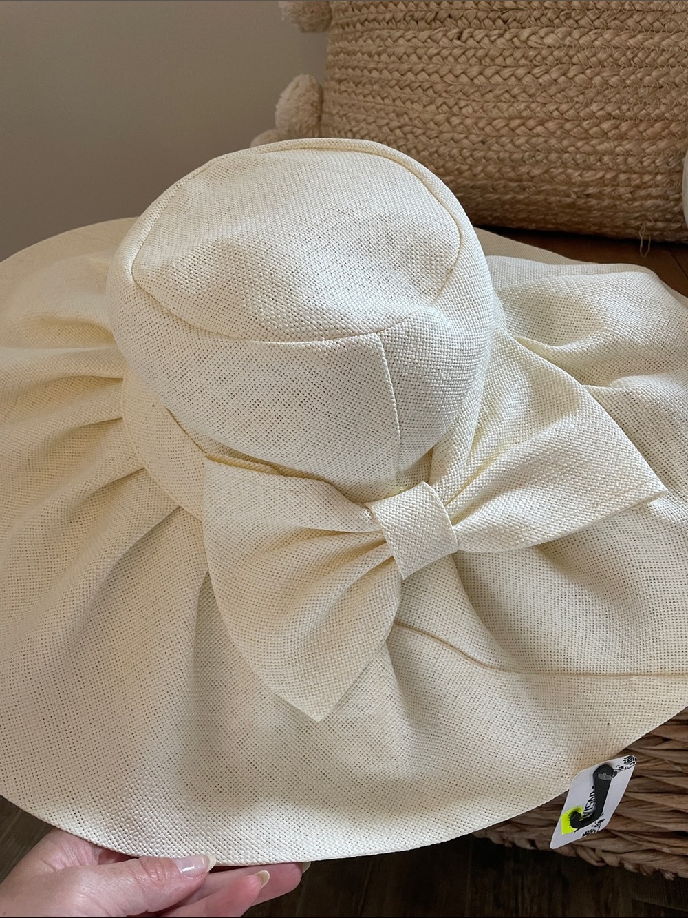 Wide brimmed ivory hat with bow.